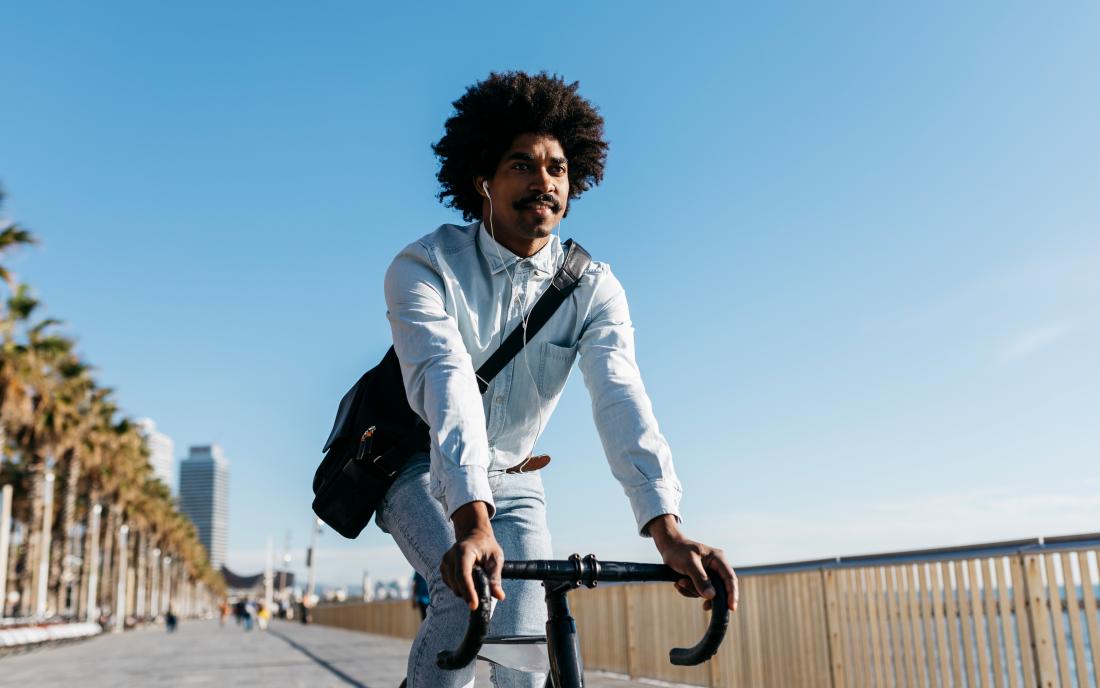 a man enjoying the benefits of aerobic exercise through cycling.